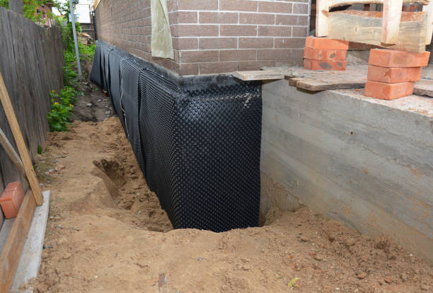 Happy homeowners after waterproofing job in Great River